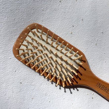 Load image into Gallery viewer, Sustainable bamboo brush with narrow paddle for travel-friendly and lightweight use