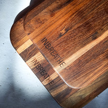Load image into Gallery viewer, Angled view of large rustic teak chopping board by InBreathe, a durable and food-safe wooden board for daily kitchen prep.
