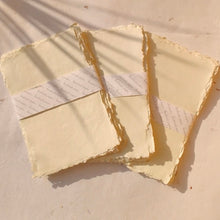 Load image into Gallery viewer, Styled deckle-edge sheet with calligraphy pen, showcasing its smooth surface and artistic use