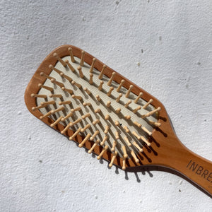 Sustainable bamboo brush with narrow paddle for travel-friendly and lightweight use