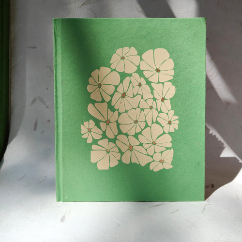 Green floral handmade hardcover notebook by InBreathe, made with recycled cotton paper and ruled pages.