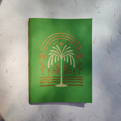 Front cover of InBreathe green softcover notebook made from handmade tree-free paper.