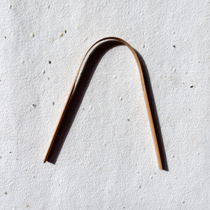 Natural bamboo tongue cleaner with smooth handle for gentle use