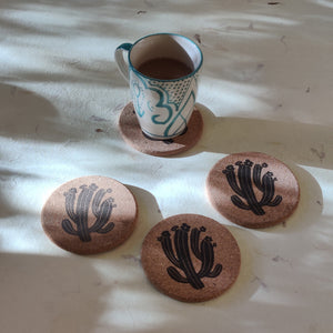 Recycled cork coaster set with hand-drawn cactus illustration for sustainable table settings.