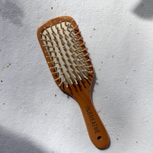 Load image into Gallery viewer, Eco-conscious slim bamboo hairbrush with soft bristles, perfect for daily detangling
