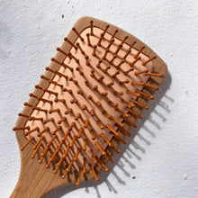 Load image into Gallery viewer, Large bamboo hairbrush with wide paddle, designed for smooth styling and reducing static

