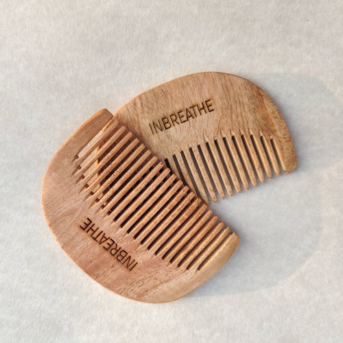 Pocket-sized neem wood hair comb by InBreathe, handcrafted from antibacterial neem wood for gentle detangling and scalp care
