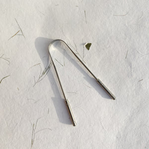 Stainless steel tongue cleaner with comfort grip and flexible non-gagging design for oral hygiene by InBreathe.